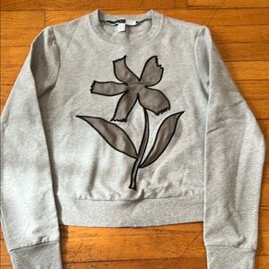 grey sweatshirt with black flower pattern on front. excellent condition